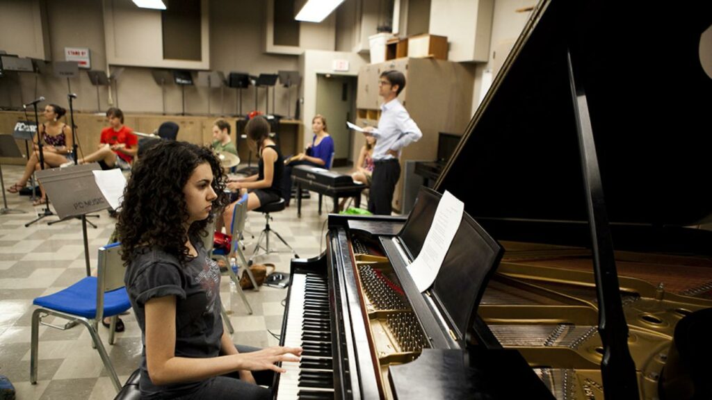 students practicing music in a university classrom