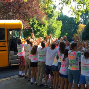 Seniors greet bus riders on the first day of school