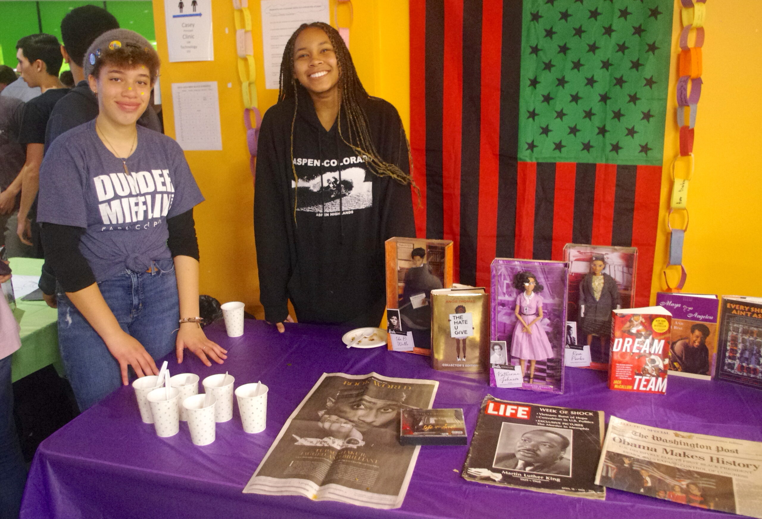 Two students standing by their culture display