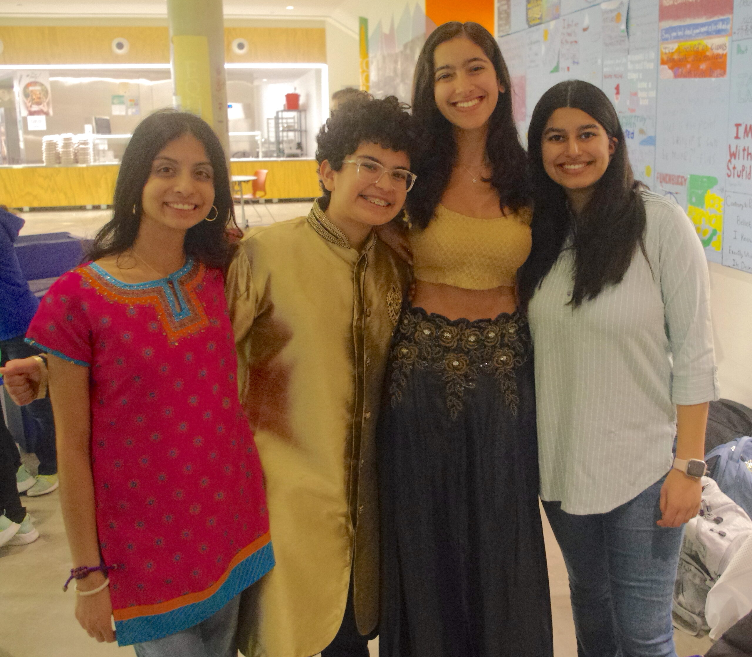 Students standing with friends in front of their culture display