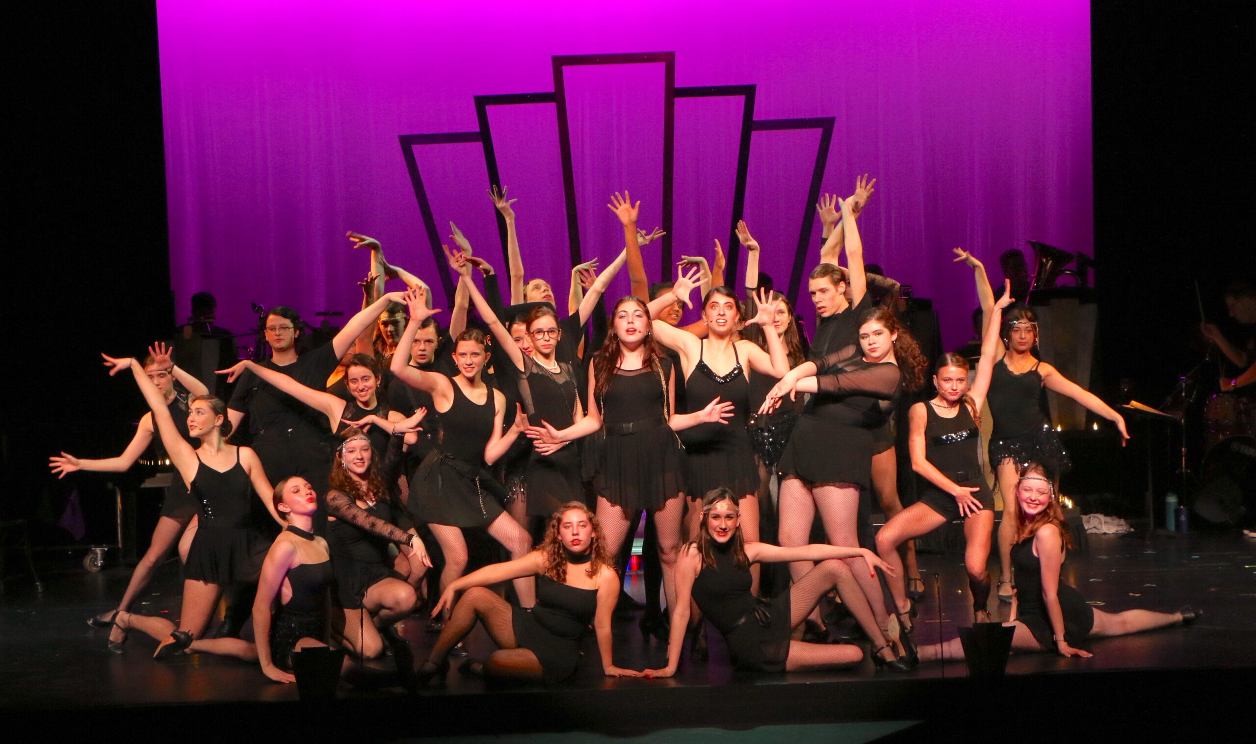 Chicago dance number - a bunch of girls dressed in black with a purple backgroud