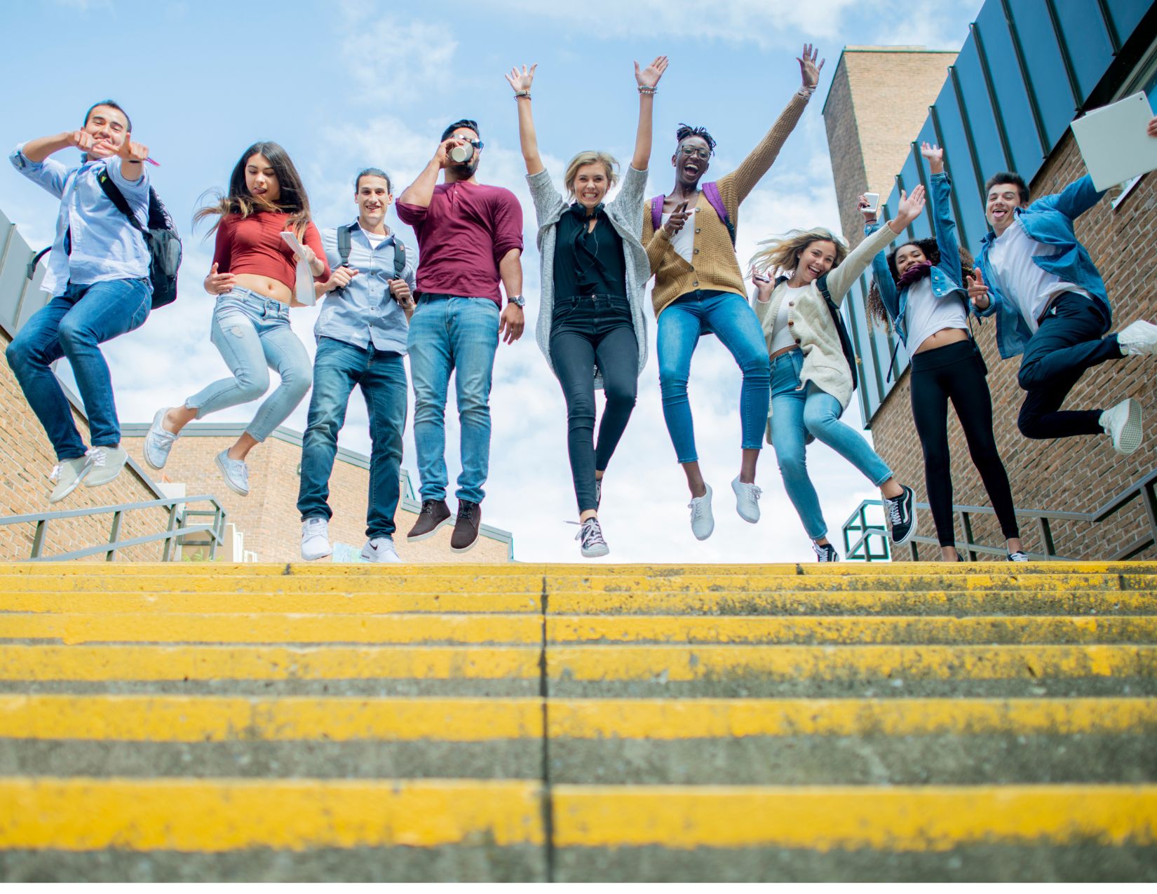 A line of students jumping in the air celebrating