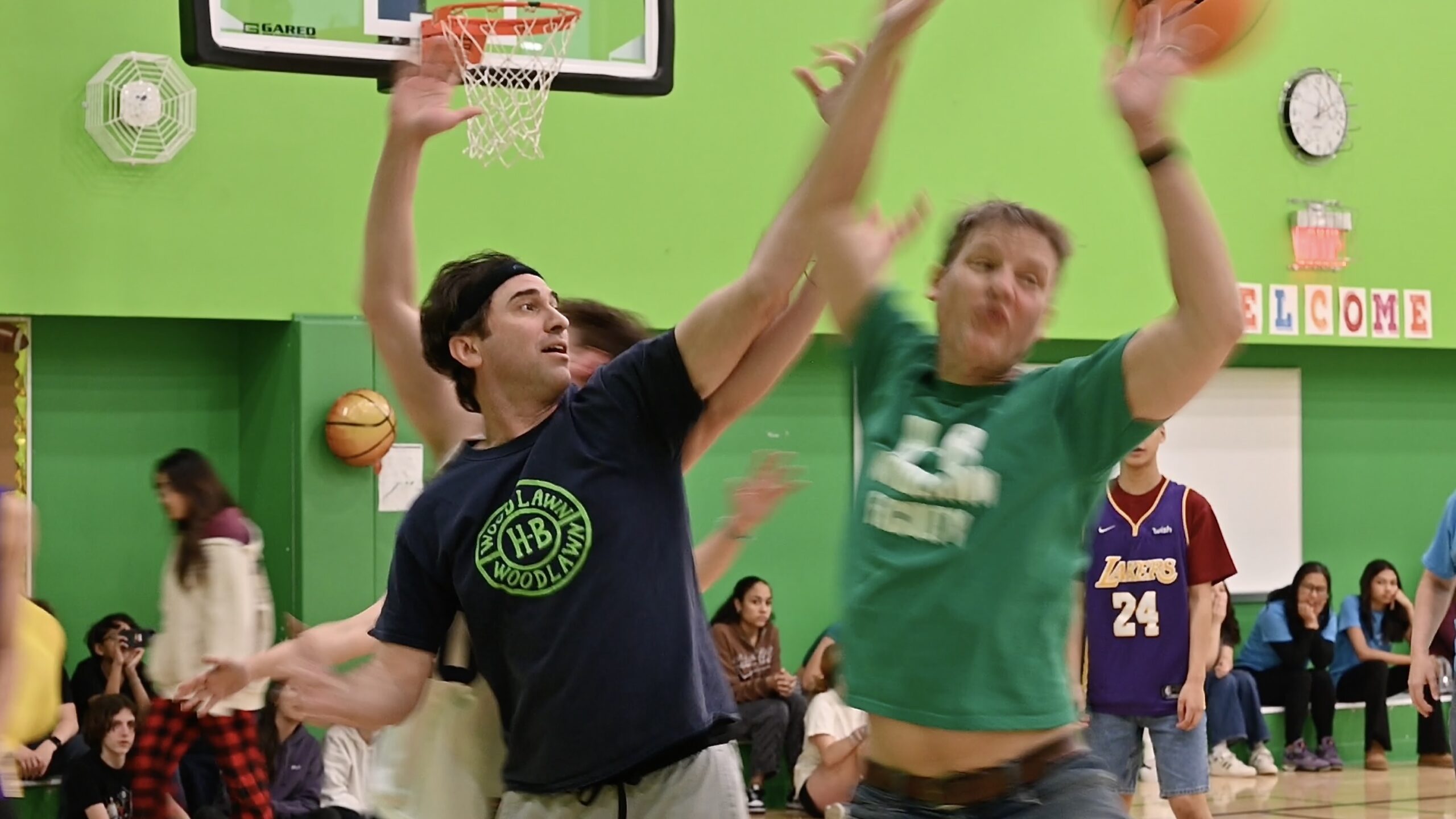 Students and teachers playing a basketball game