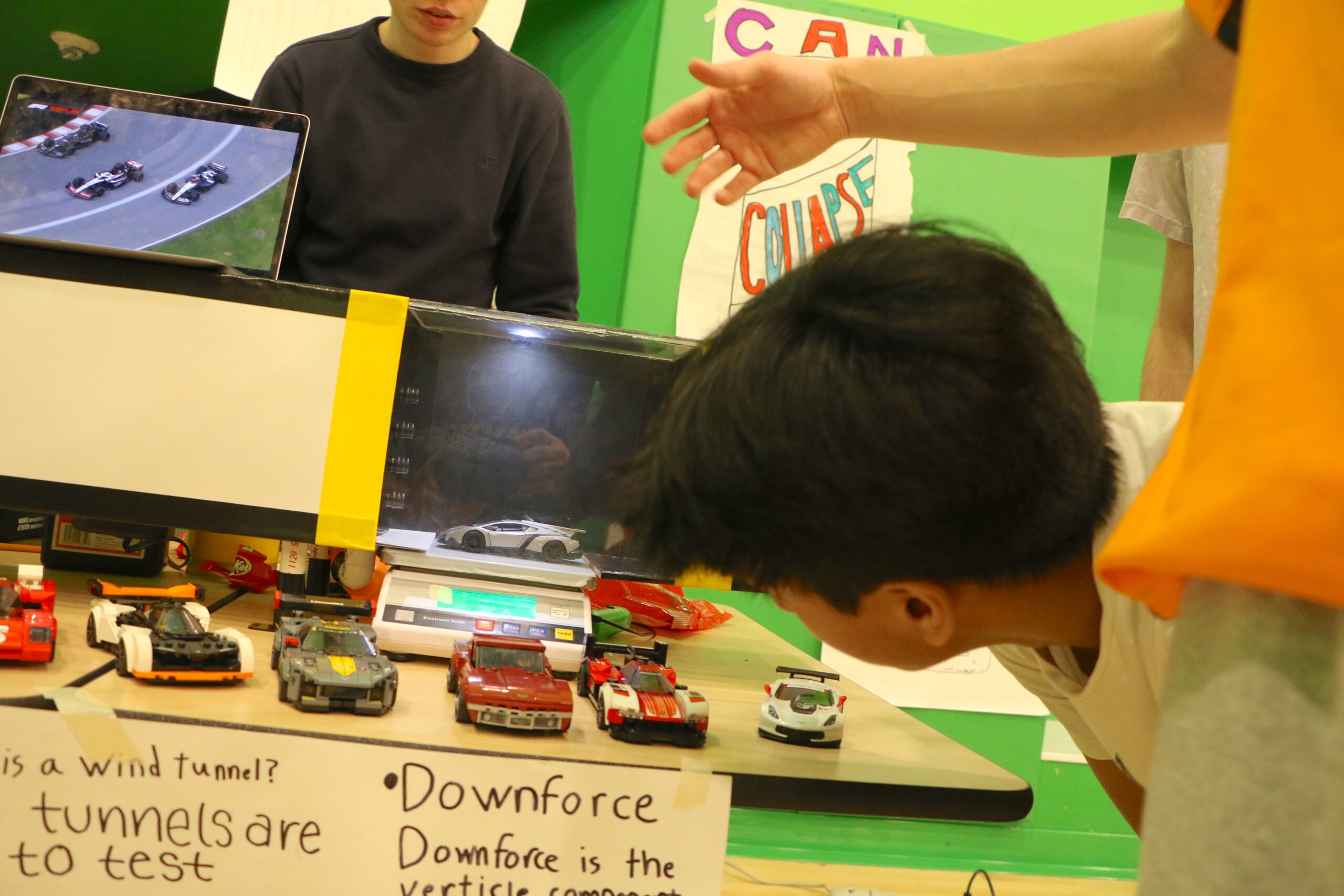 Students looking at toy cars