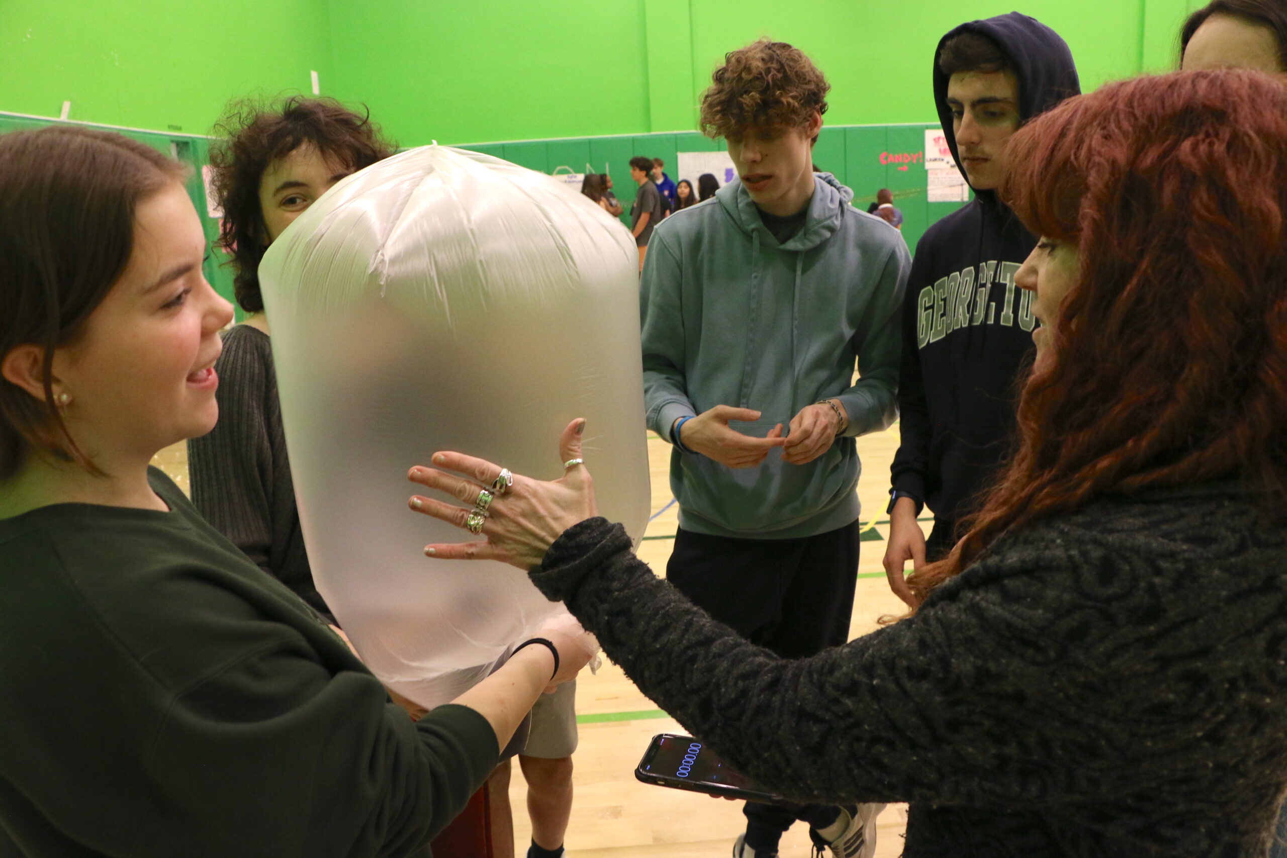 Students playing with an inflated plastic bag