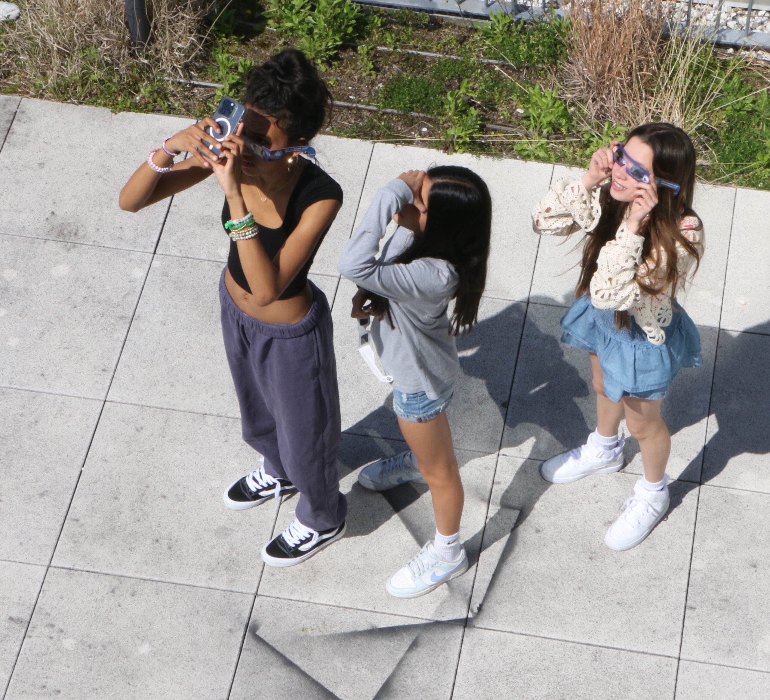 Three students viewing the eclipse