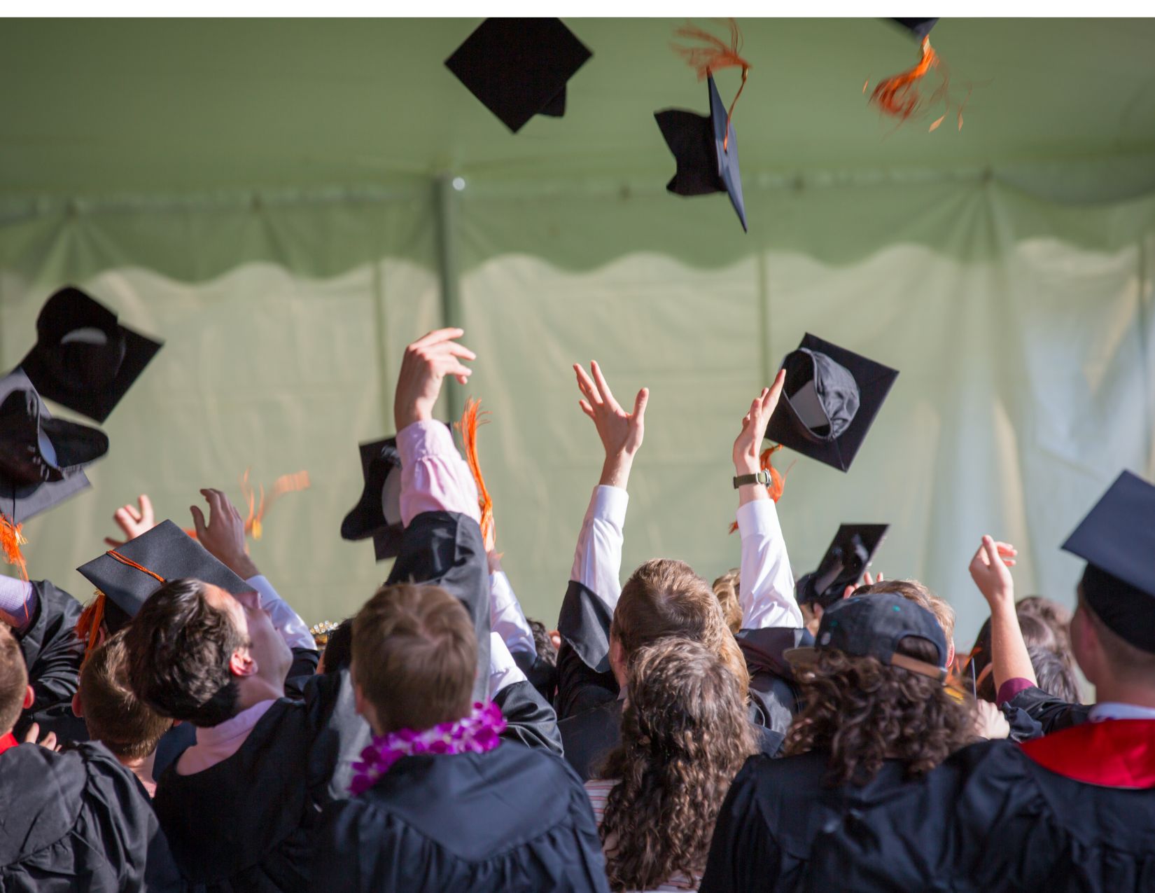 Students graduating and throwing their caps in the air