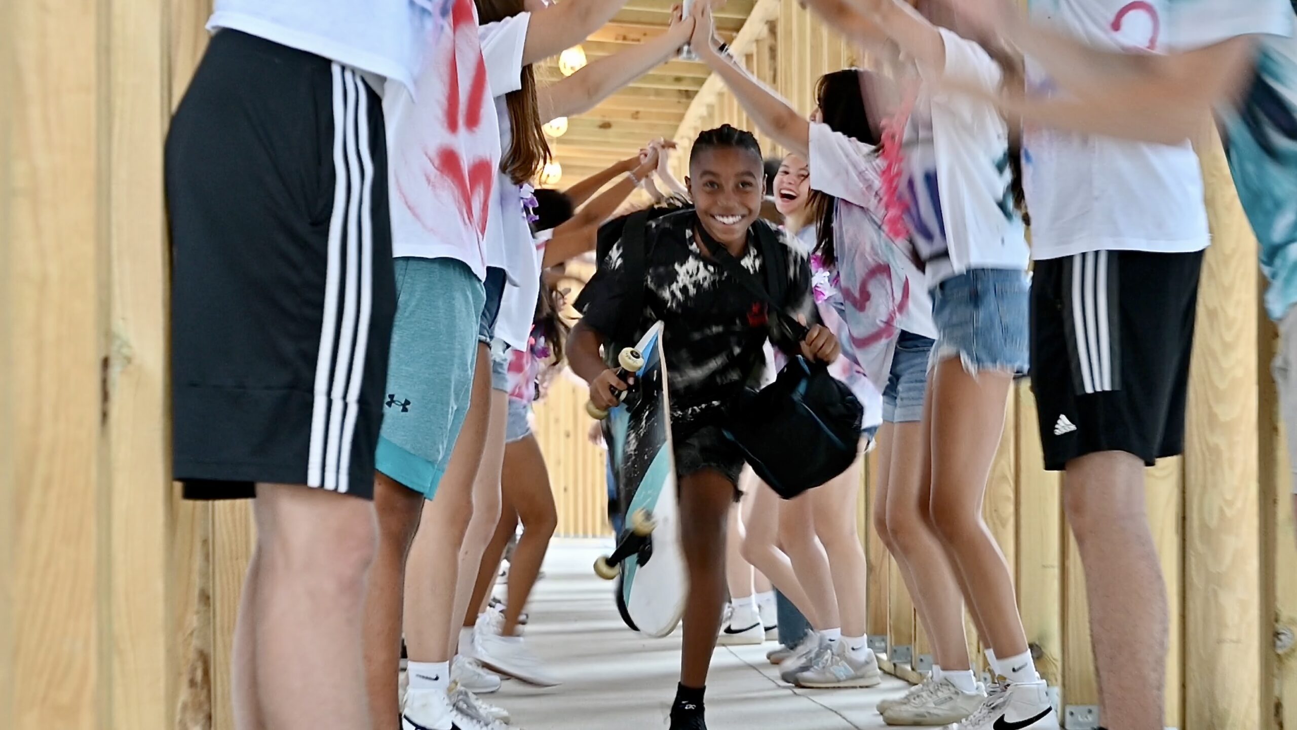 Student running into school under the senior arm-tunnel