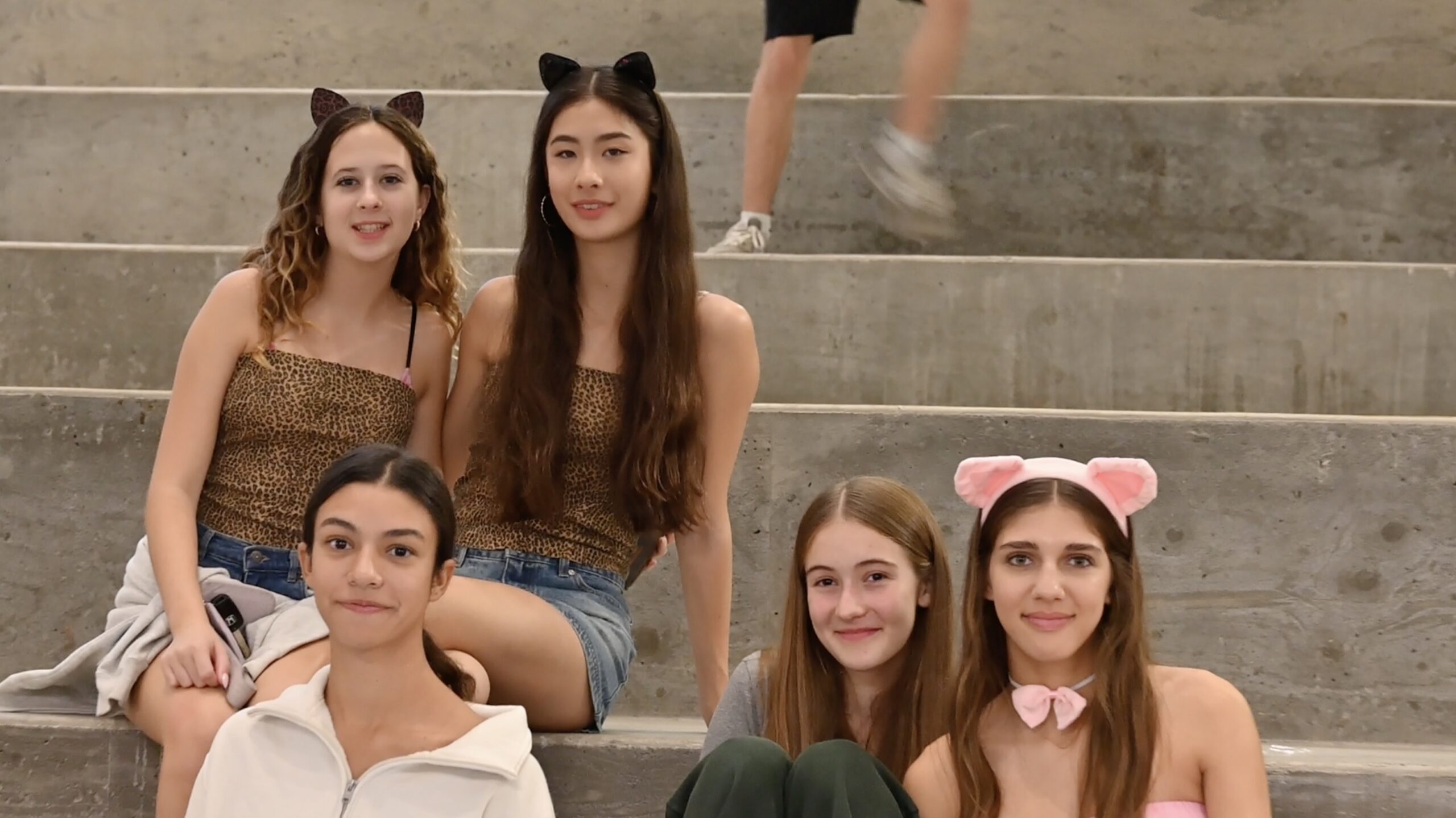 Group of students in costume sitting on the stairs