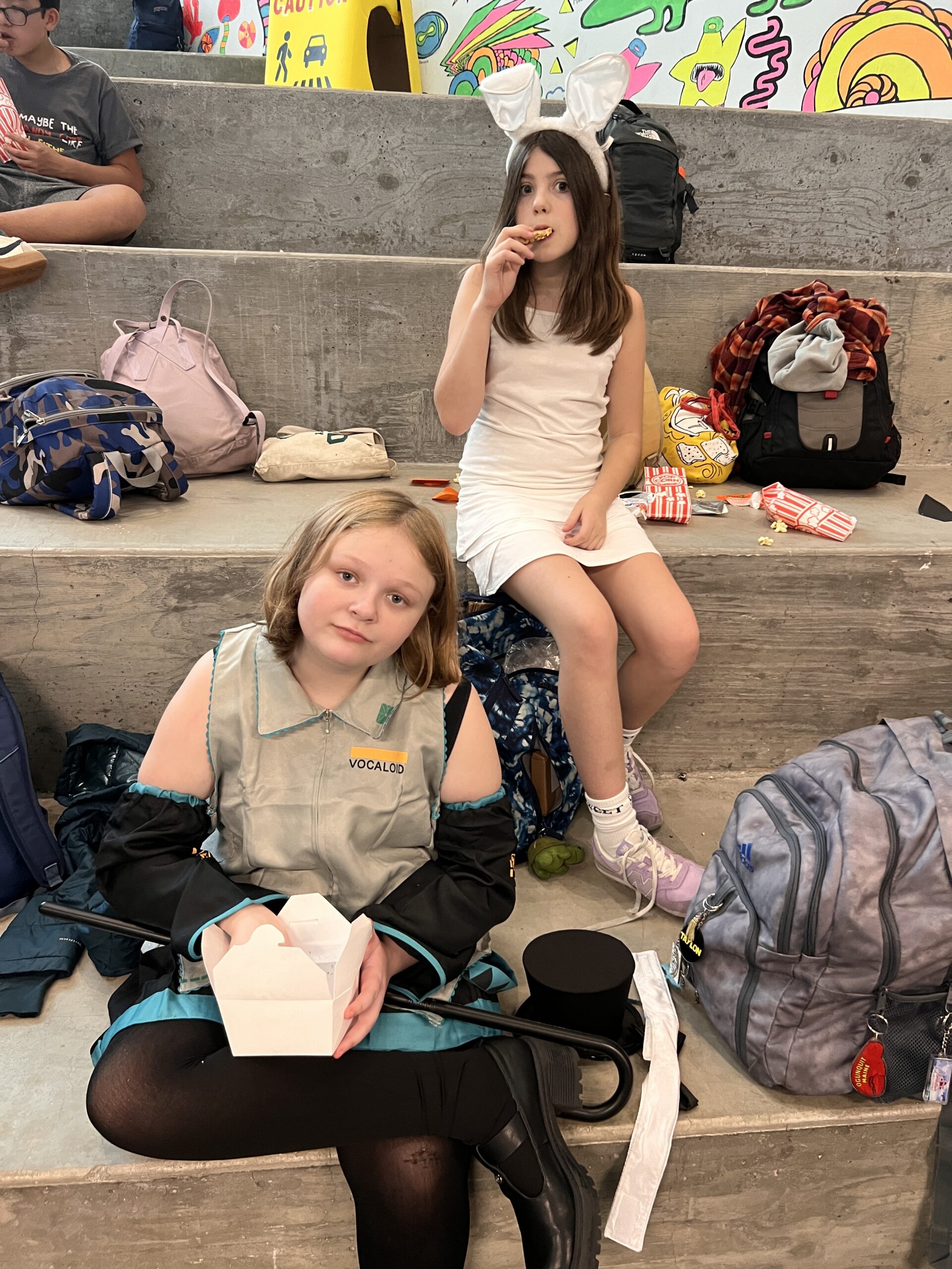 Middle schooler in costume sitting on the stairs