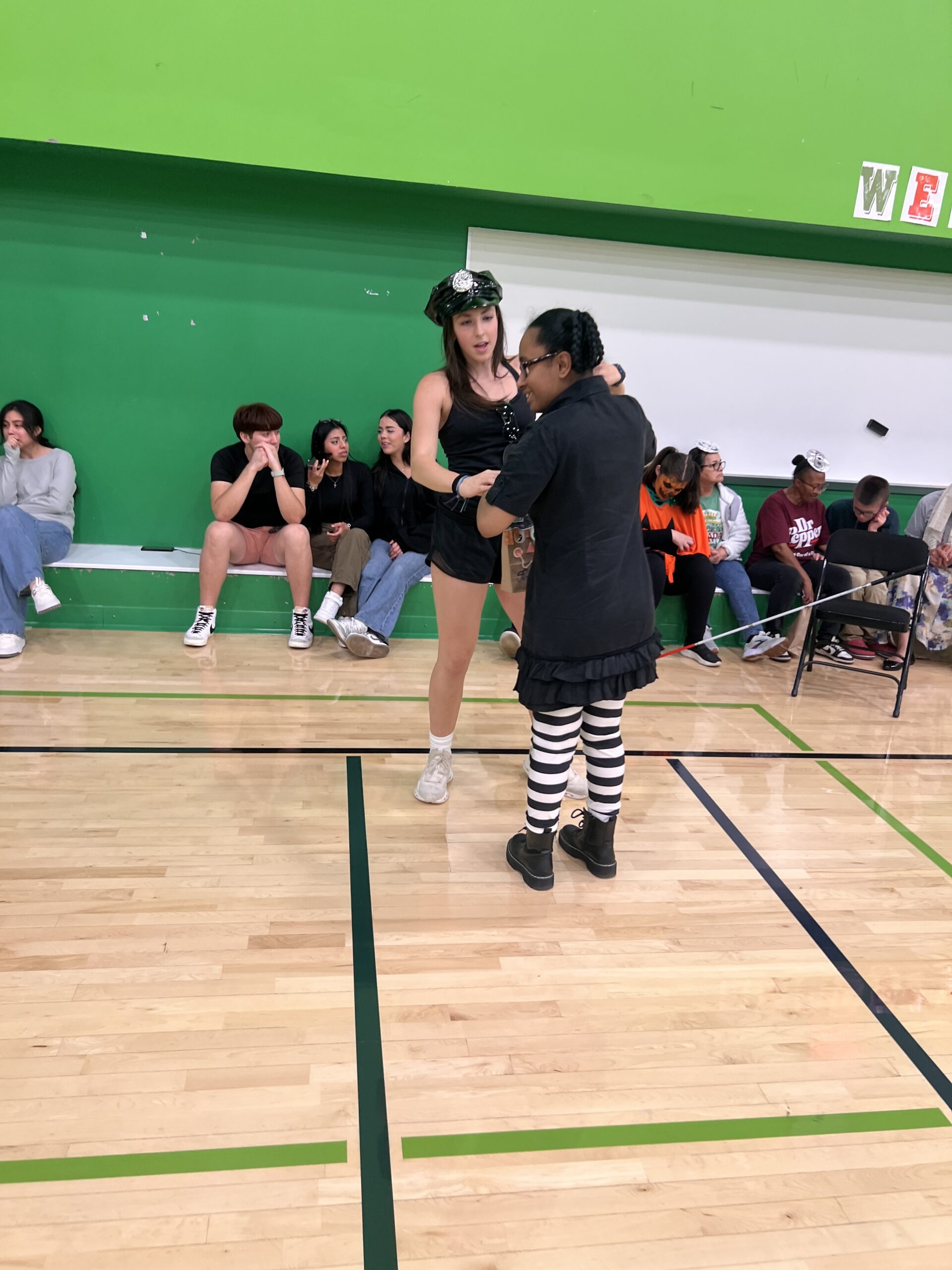 Policewoman dancing with another student