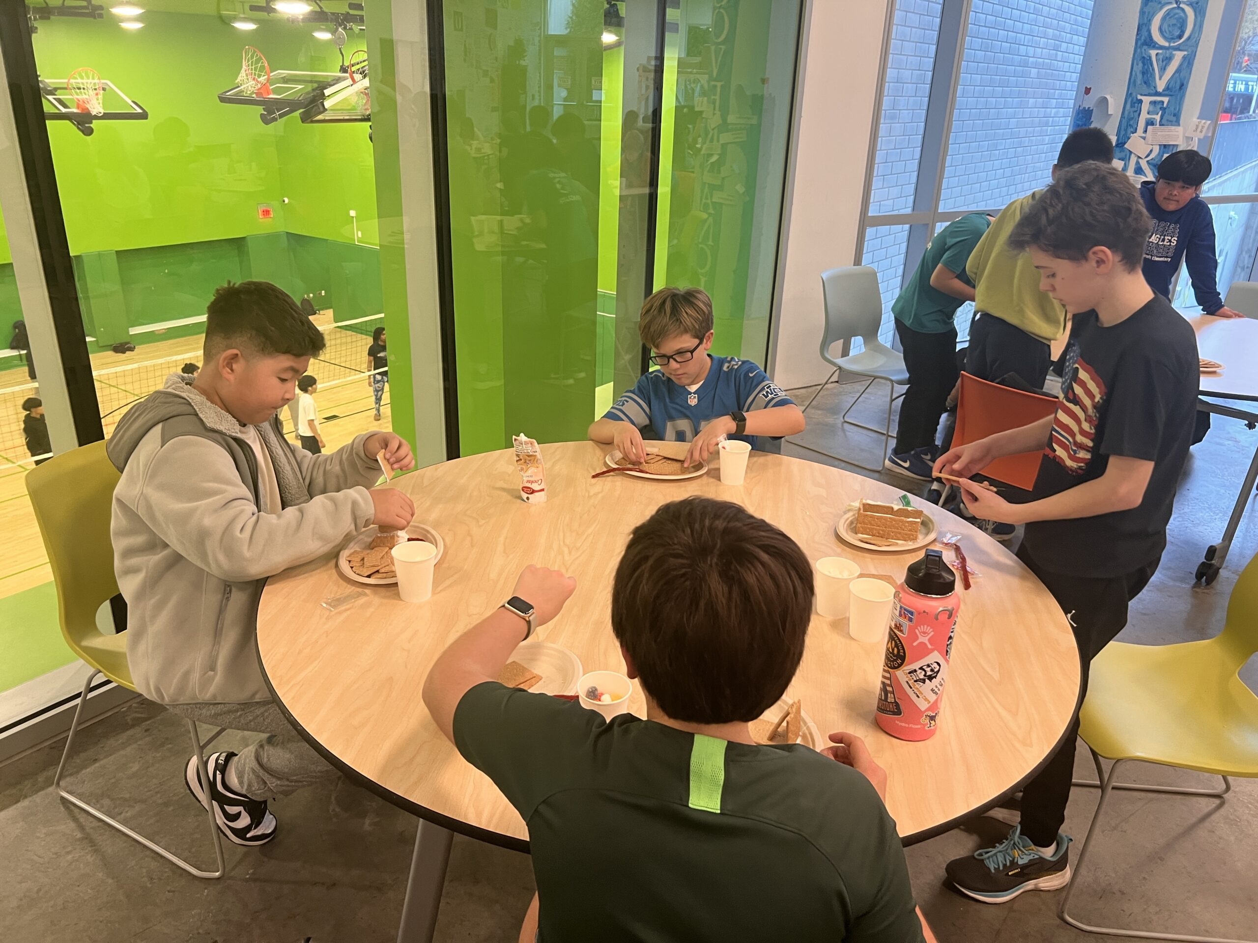 Students making gingerbread houses