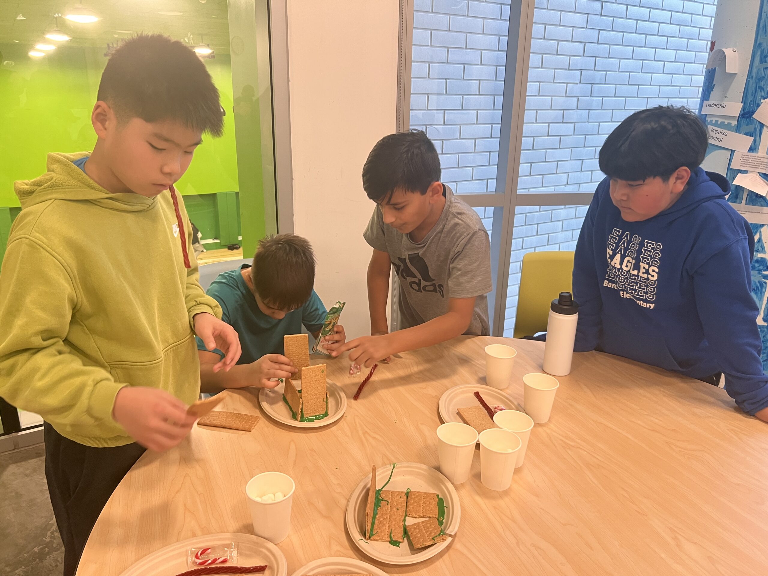 Students making gingerbread houses