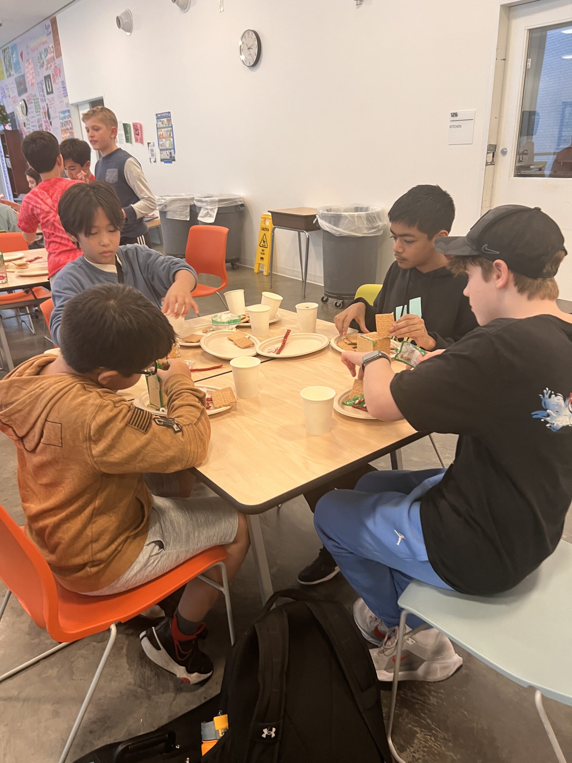 Students making gingerbread houses