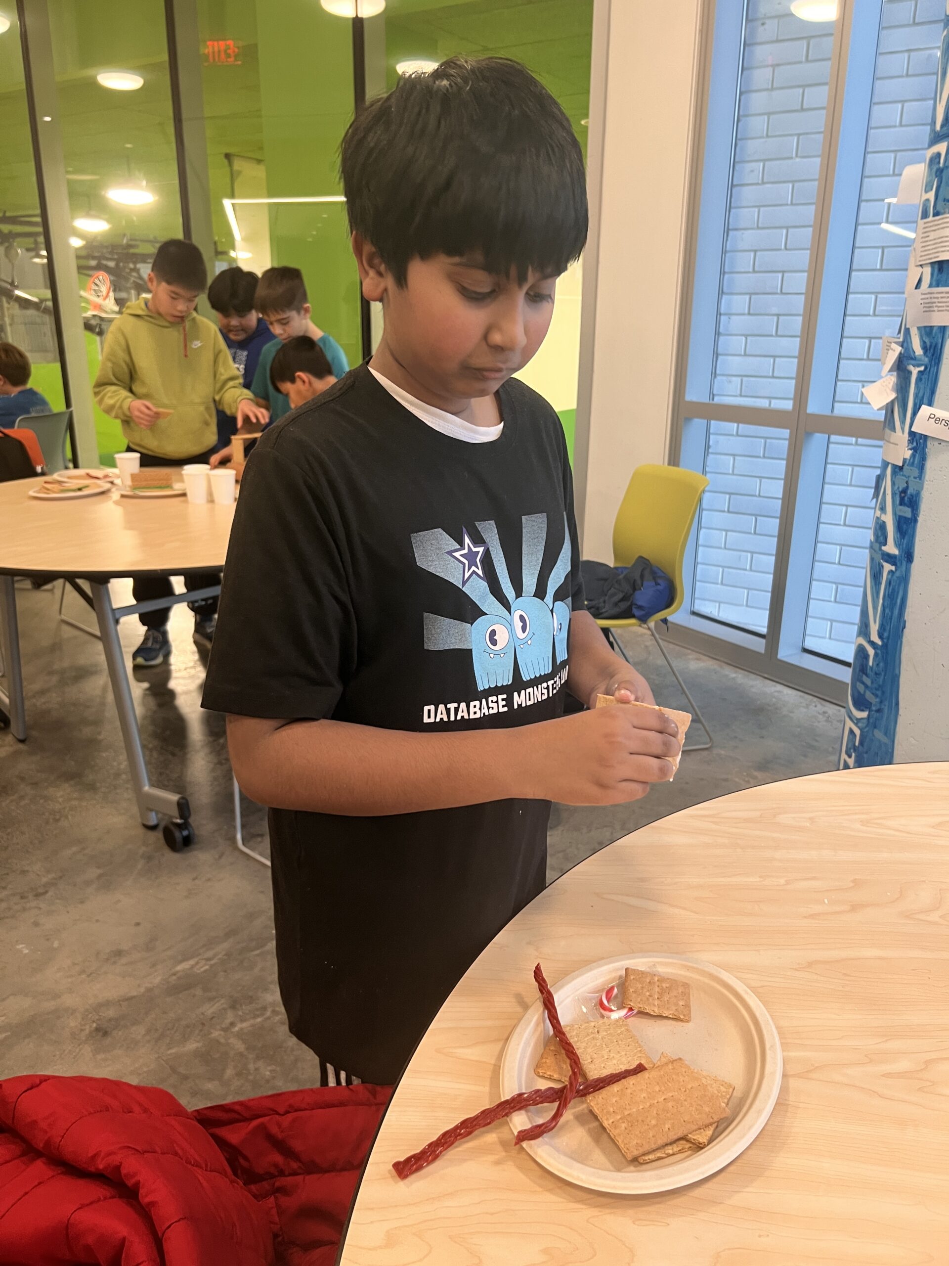 Students making gingerbread houses