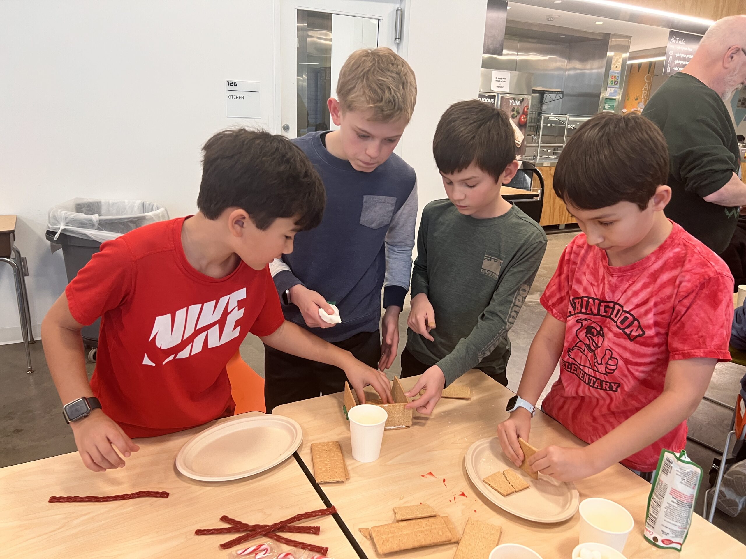 Students making gingerbread houses