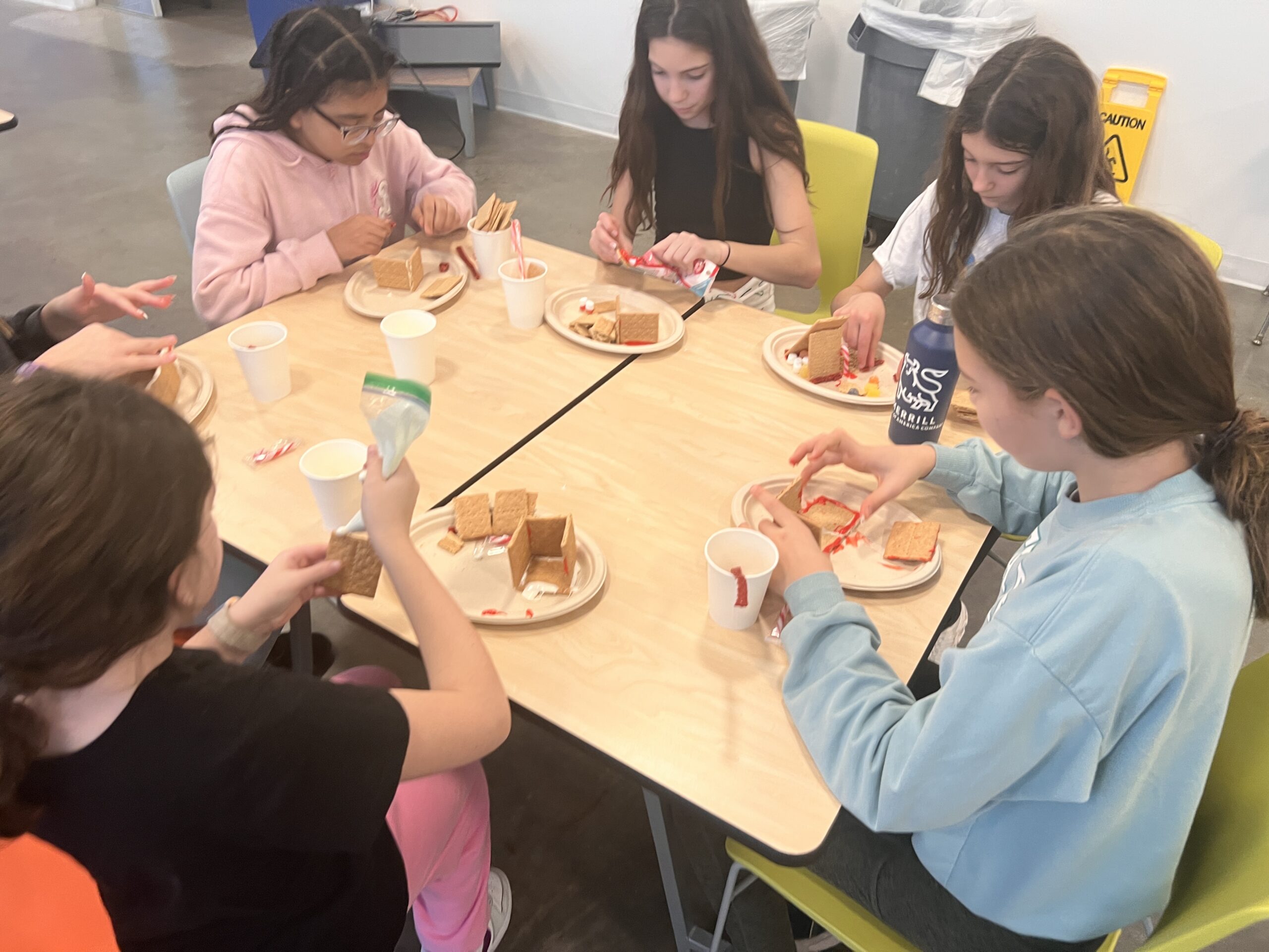 Students making gingerbread houses