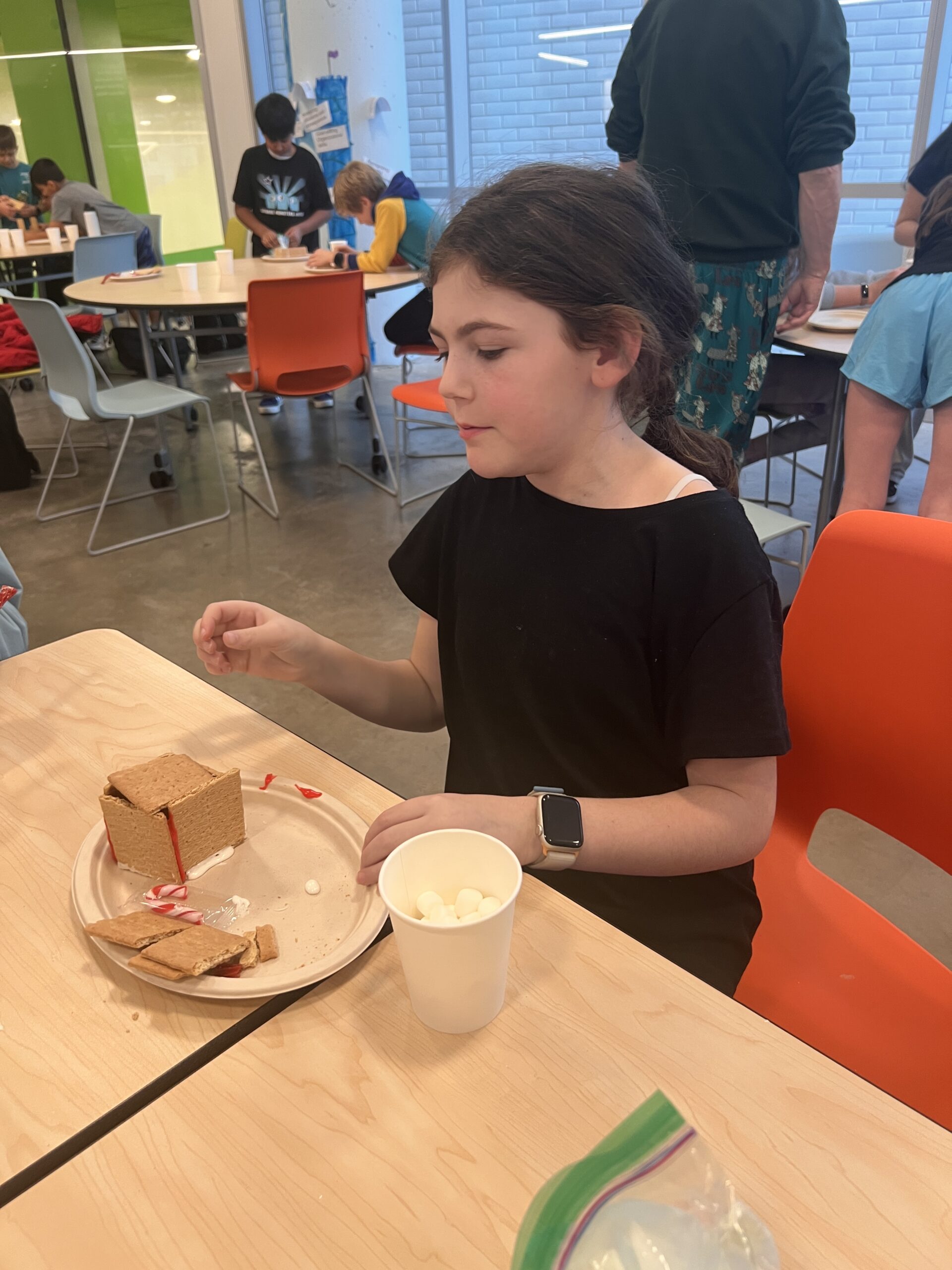 Students making gingerbread houses