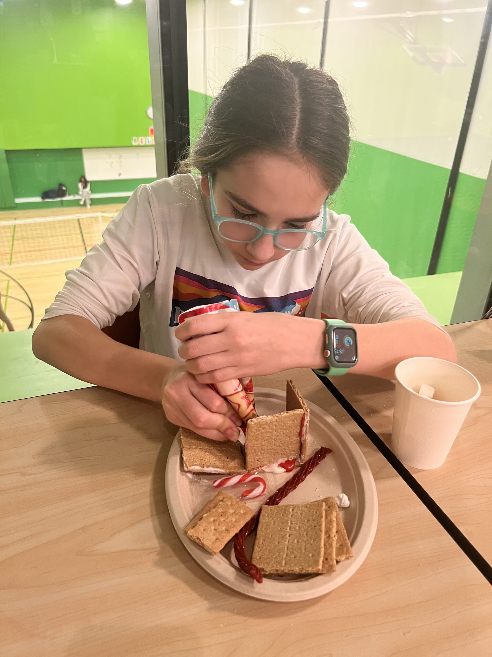 Students making gingerbread houses