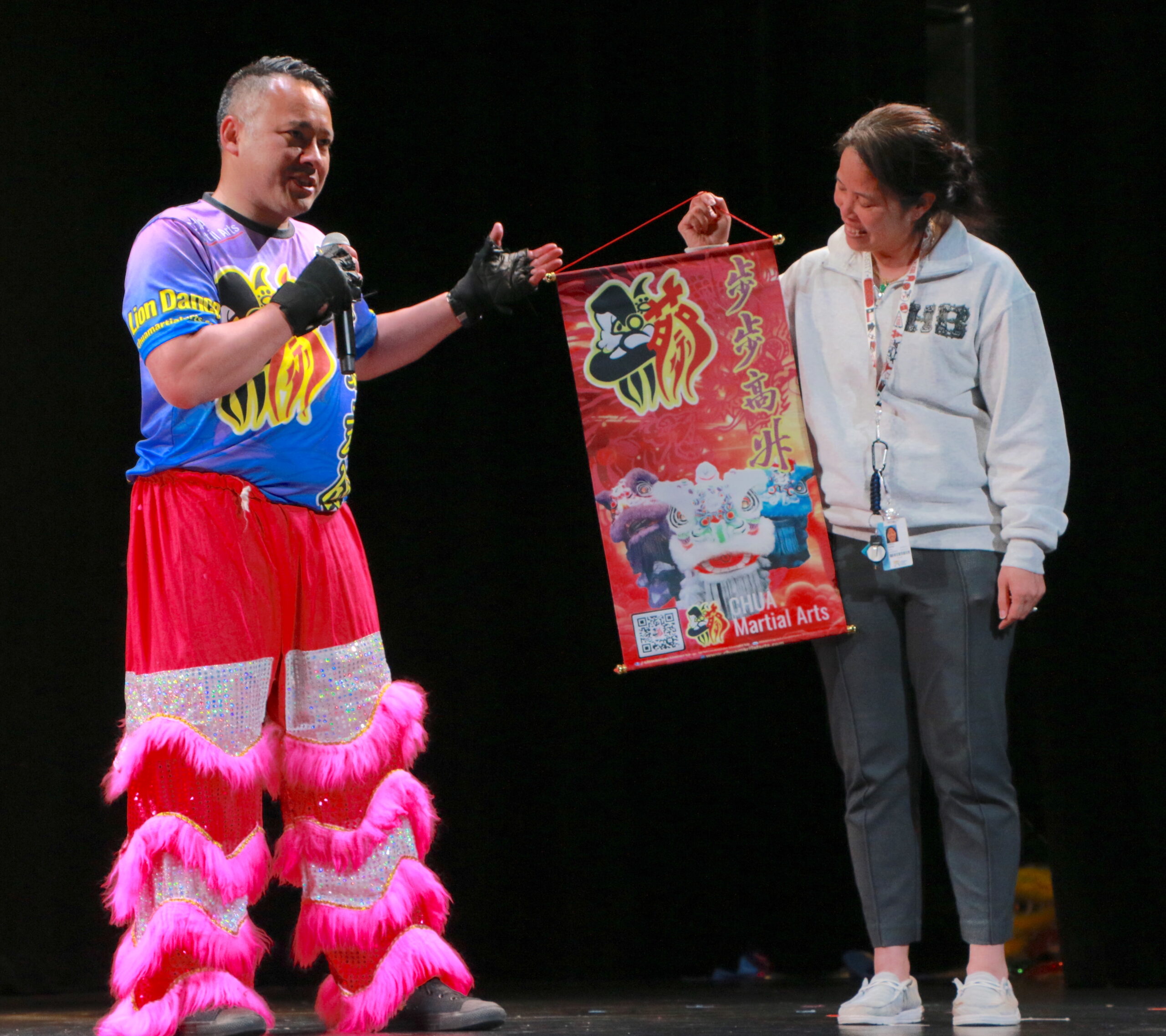 Lion dancer giving a gift to a teacher
