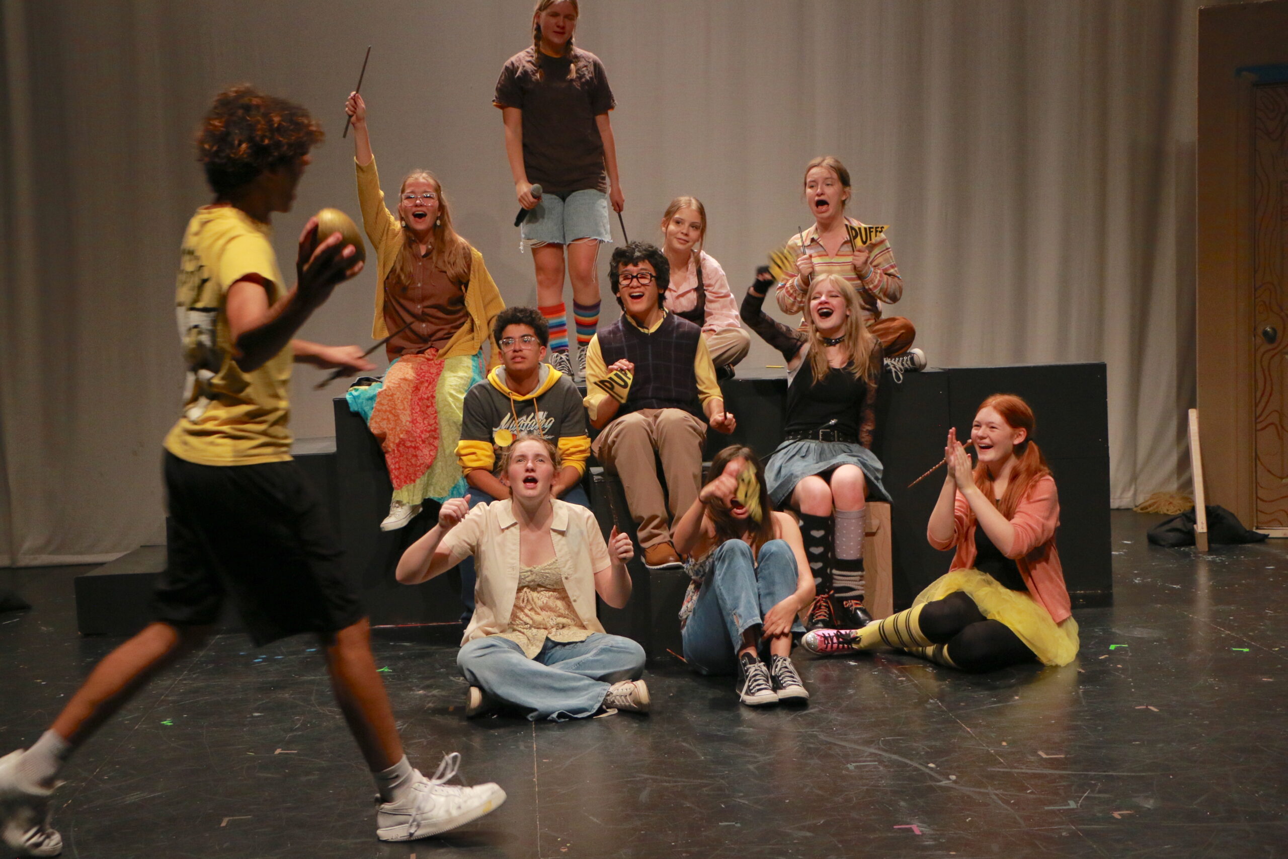 Student actors performing in Puffs